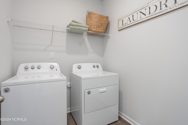 laundry area featuring washer and clothes dryer, laundry area, and baseboards