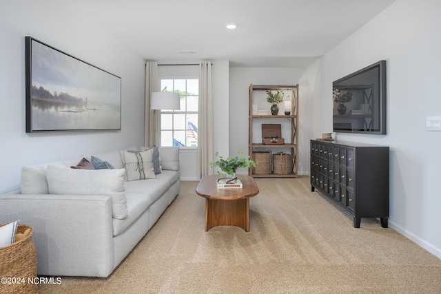 living room featuring recessed lighting, mail area, baseboards, and light colored carpet