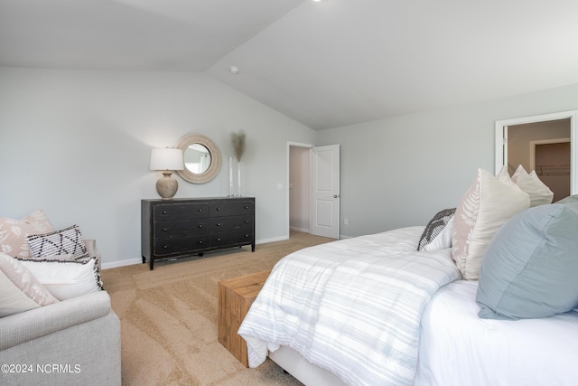 carpeted bedroom with baseboards and lofted ceiling