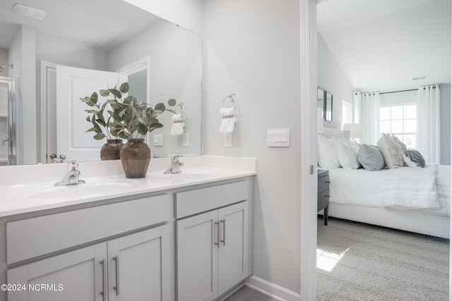 full bathroom featuring ensuite bath, double vanity, visible vents, and a sink