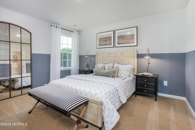 carpeted bedroom with visible vents and baseboards