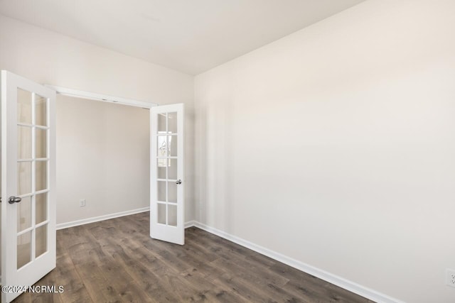 unfurnished room with dark wood-type flooring, french doors, and baseboards