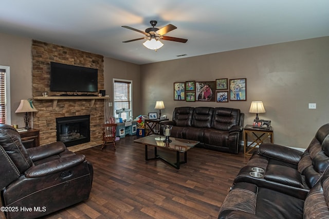 living area with ceiling fan, wood finished floors, and a fireplace