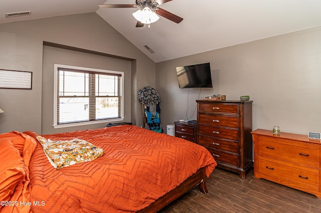 bedroom with vaulted ceiling, visible vents, dark wood-style flooring, and ceiling fan