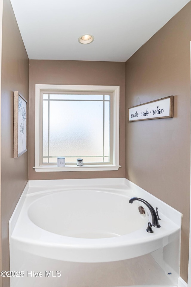 full bathroom with recessed lighting and a garden tub