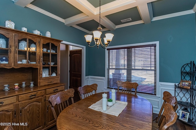 dining area with a chandelier, beamed ceiling, wainscoting, and visible vents