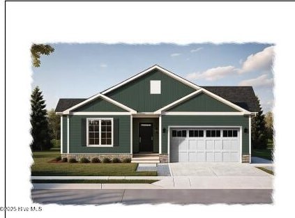 view of front of home featuring driveway, a front yard, and a garage