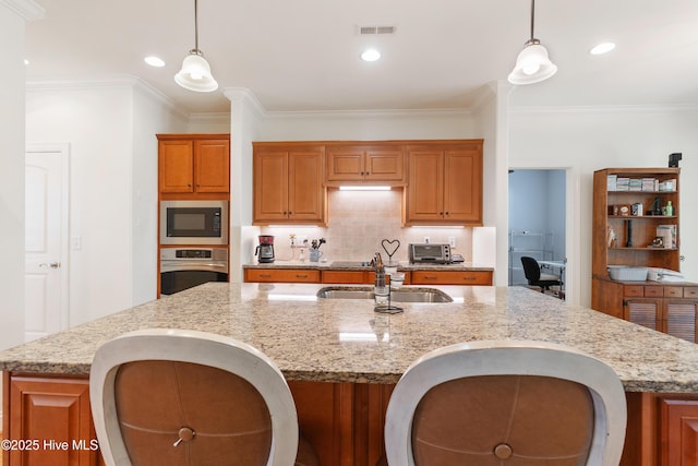 kitchen with visible vents, a kitchen island with sink, a sink, stainless steel oven, and built in microwave