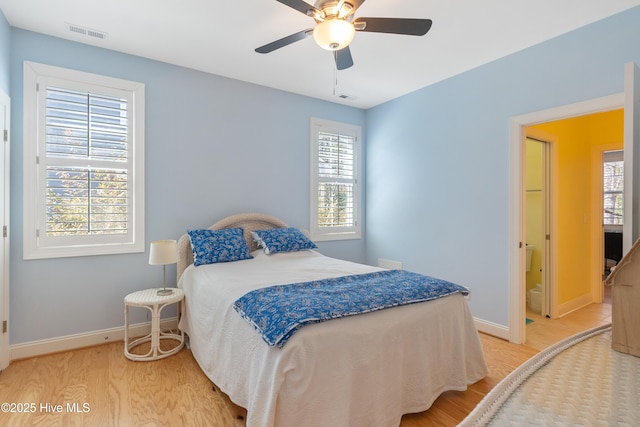 bedroom featuring baseboards, visible vents, and light wood-type flooring