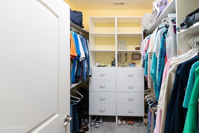 spacious closet featuring visible vents and carpet floors