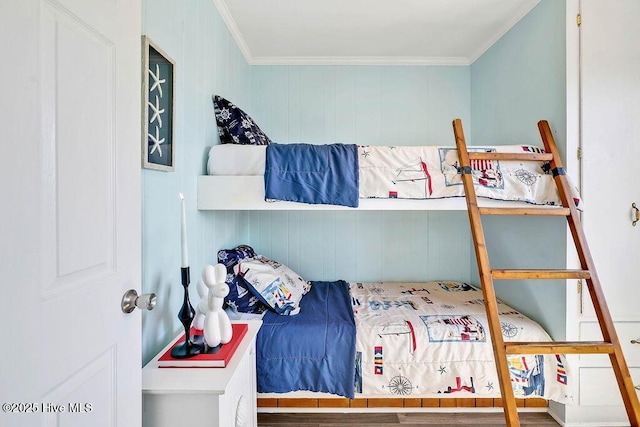 bedroom featuring wood finished floors and ornamental molding