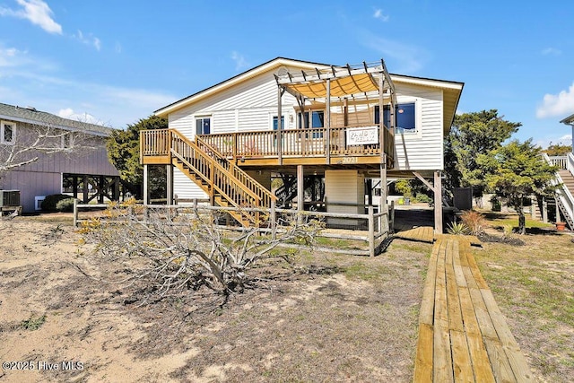 back of house featuring stairway, central AC unit, and a wooden deck