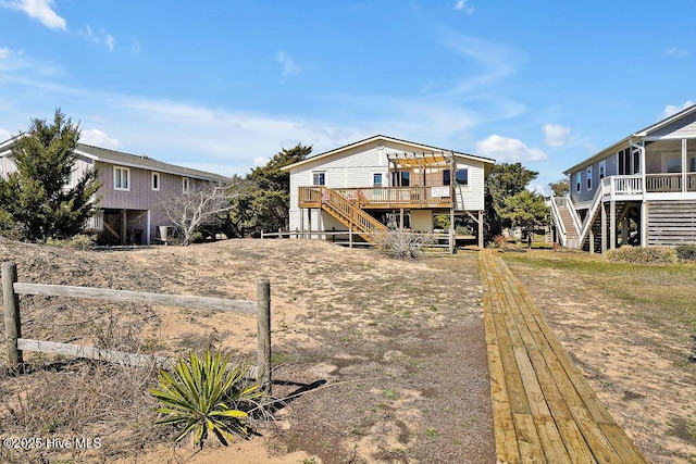 back of property featuring stairs and a deck