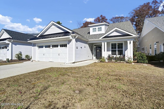 view of front of property with a front lawn, a porch, a garage, driveway, and a standing seam roof