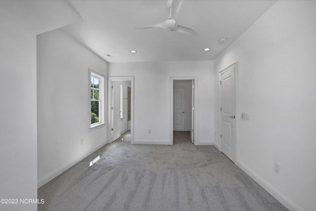 unfurnished bedroom featuring carpet, baseboards, recessed lighting, ceiling fan, and ensuite bathroom