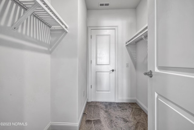 spacious closet with visible vents and carpet