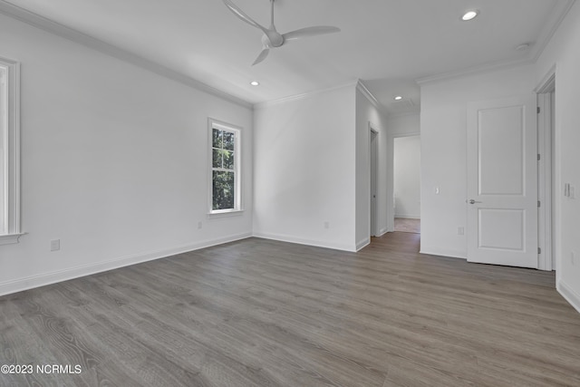 spare room with crown molding, baseboards, ceiling fan, recessed lighting, and wood finished floors