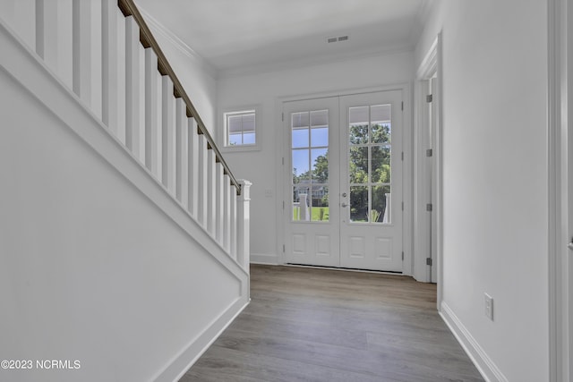 entryway with wood finished floors, french doors, visible vents, and baseboards