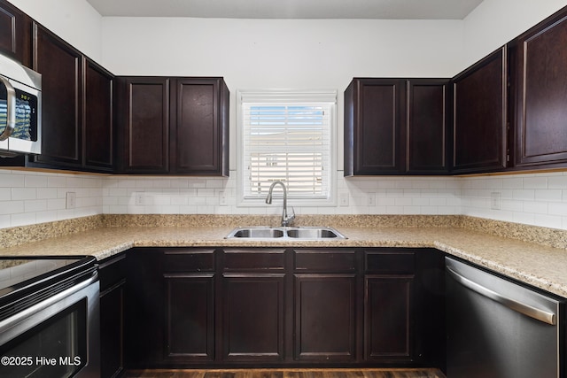 kitchen featuring a sink, tasteful backsplash, stainless steel appliances, light countertops, and dark brown cabinets