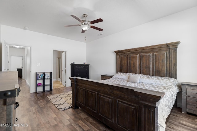 bedroom featuring a ceiling fan, wood finished floors, and baseboards