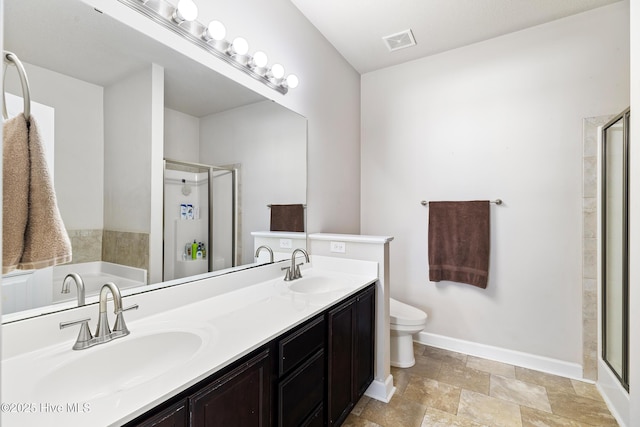 bathroom featuring a stall shower, baseboards, visible vents, and a sink