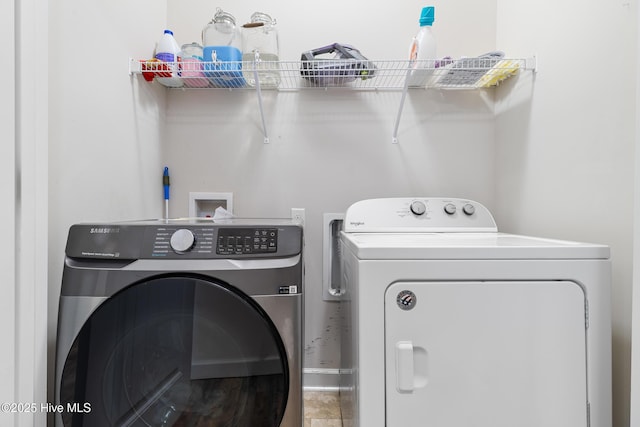 clothes washing area with laundry area and washer and clothes dryer