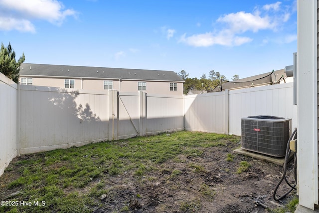 view of yard with central air condition unit and a fenced backyard