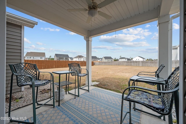 view of patio featuring a fenced backyard, a residential view, and ceiling fan