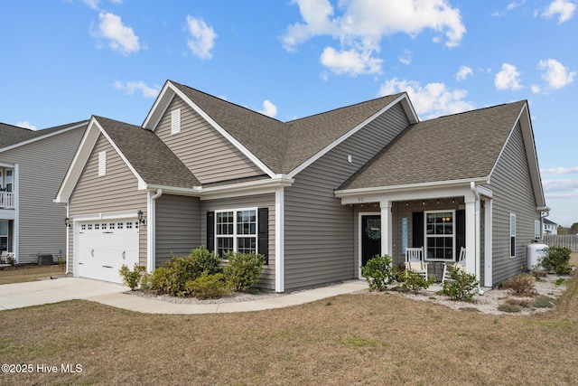 view of front facade featuring driveway, a front lawn, a garage, and roof with shingles