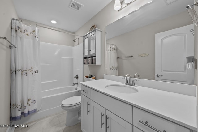 full bathroom featuring vanity, visible vents, tile patterned flooring, shower / bath combo with shower curtain, and toilet