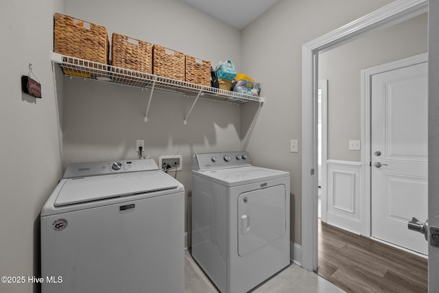 washroom with laundry area, light wood-style floors, and separate washer and dryer