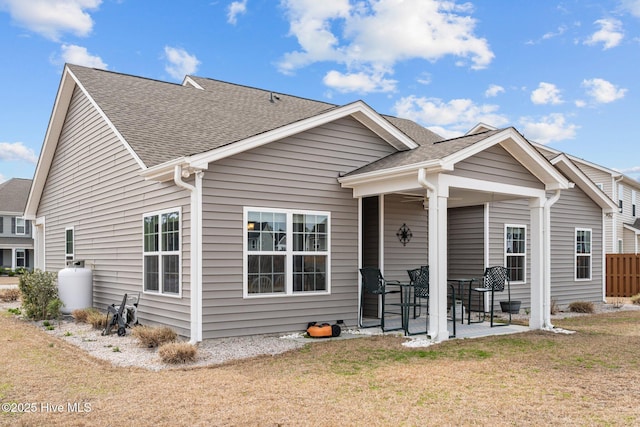 back of property featuring a yard and a patio