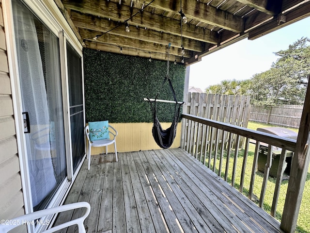 wooden deck with a lawn and fence