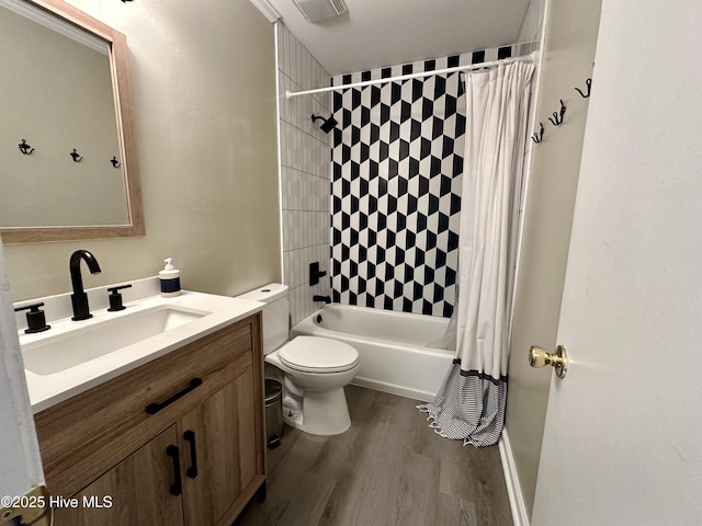 bathroom with visible vents, toilet, shower / tub combo with curtain, wood finished floors, and vanity