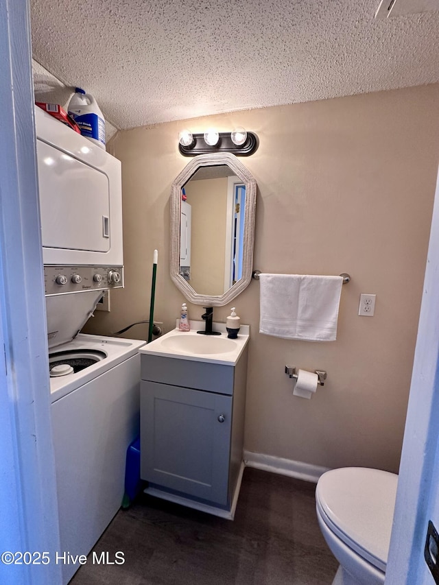 bathroom with toilet, vanity, baseboards, and wood finished floors