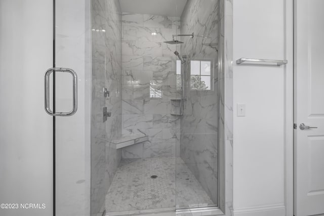 full bathroom featuring a marble finish shower