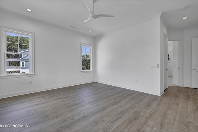 unfurnished room with wood finished floors, a ceiling fan, baseboards, recessed lighting, and crown molding