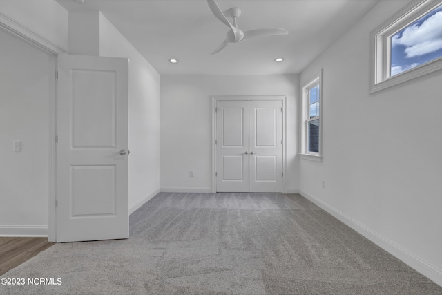 unfurnished bedroom with recessed lighting, baseboards, and a closet