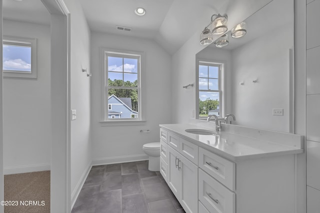 bathroom featuring visible vents, toilet, vanity, and baseboards