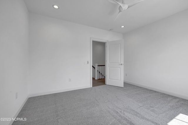 empty room with recessed lighting, baseboards, a ceiling fan, and carpet flooring