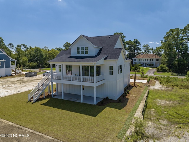 view of front of house with a patio, stairs, a front yard, and roof with shingles