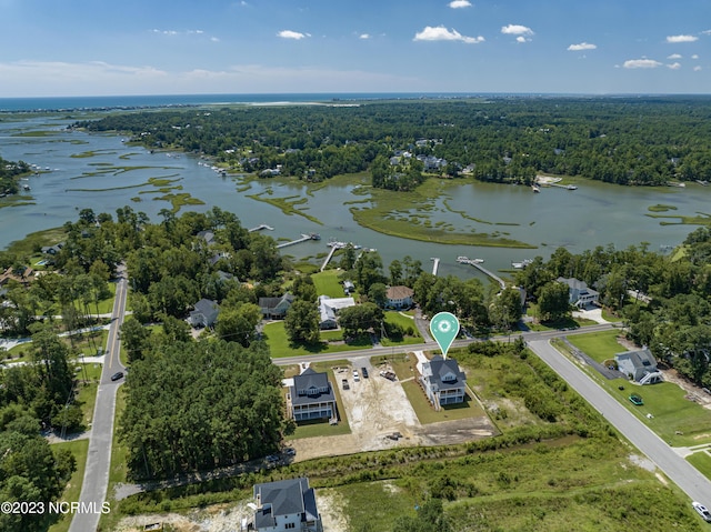 aerial view featuring a forest view and a water view