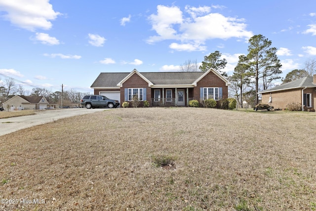 ranch-style home with a garage, brick siding, concrete driveway, and a front lawn