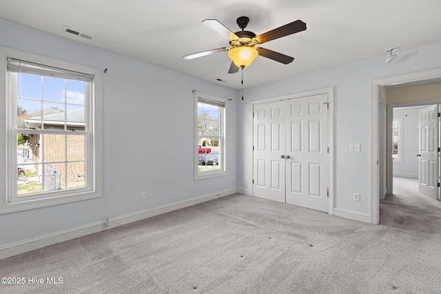 unfurnished bedroom featuring a closet, baseboards, visible vents, and carpet floors