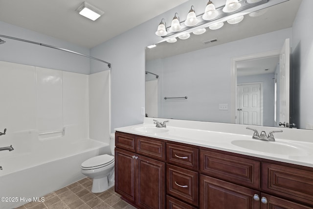 bathroom featuring double vanity, toilet, visible vents, and a sink