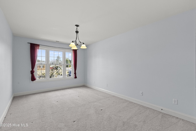 carpeted empty room with baseboards