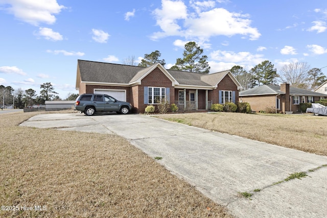 ranch-style house with a front yard, brick siding, concrete driveway, and an attached garage