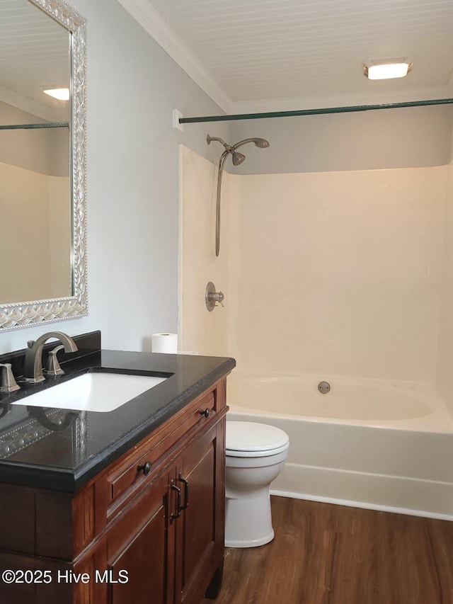 full bathroom featuring toilet, shower / tub combination, wood finished floors, crown molding, and vanity