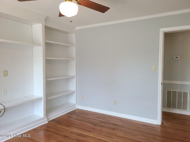 spare room with visible vents, baseboards, a ceiling fan, and wood finished floors