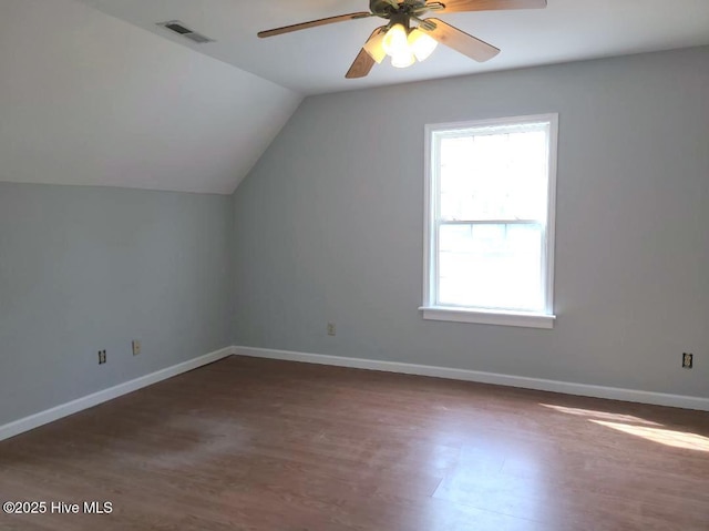 bonus room with wood finished floors, visible vents, baseboards, lofted ceiling, and ceiling fan